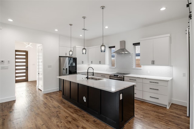 3502 Vilbig Rd, Dallas, TX 75212 - kitchen featuring stainless steel appliances, wall chimney exhaust hood, a sink, tasteful backsplash, and white cabinetry