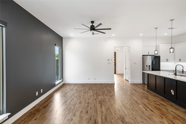 3502 Vilbig Rd, Dallas, TX 75212 - kitchen featuring light countertops, a ceiling fan, stainless steel fridge, white cabinets, and hanging light fixtures