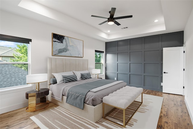3502 Vilbig Rd, Dallas, TX 75212 - bedroom featuring a raised ceiling, a decorative wall, wood finished floors, recessed lighting, and baseboards