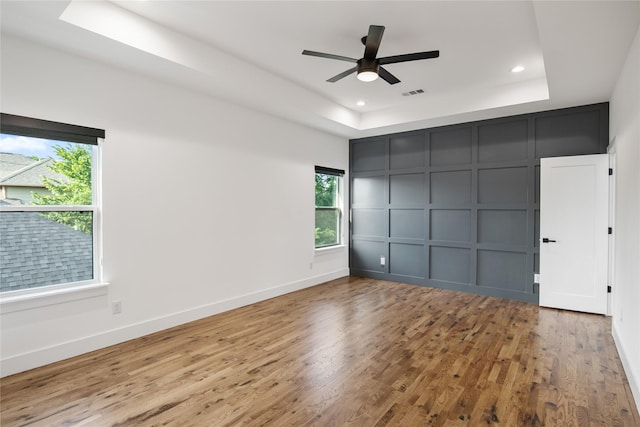3502 Vilbig Rd, Dallas, TX 75212 - unfurnished bedroom featuring a decorative wall, a raised ceiling, wood finished floors, recessed lighting, and baseboards
