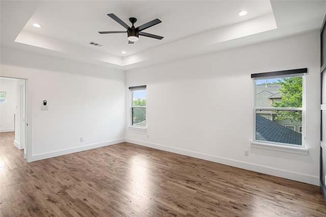 3502 Vilbig Rd, Dallas, TX 75212 - empty room featuring a tray ceiling, healthy amount of natural light, wood finished floors, and recessed lighting