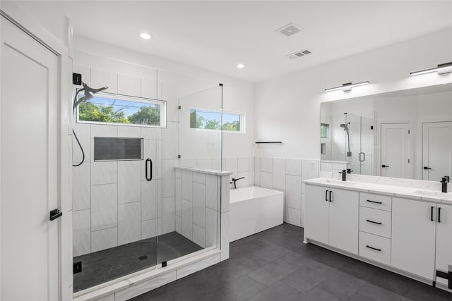 3502 Vilbig Rd, Dallas, TX 75212 - full bathroom featuring a garden tub, a stall shower, double vanity, tile patterned flooring, and recessed lighting