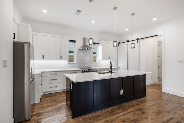 3502 Vilbig Rd, Dallas, TX 75212 - kitchen featuring appliances with stainless steel finishes, wall chimney exhaust hood, a sink, backsplash, and white cabinets