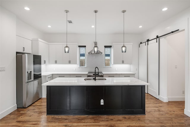 3502 Vilbig Rd, Dallas, TX 75212 - kitchen with stainless steel fridge, a sink, a barn door, tasteful backsplash, and recessed lighting