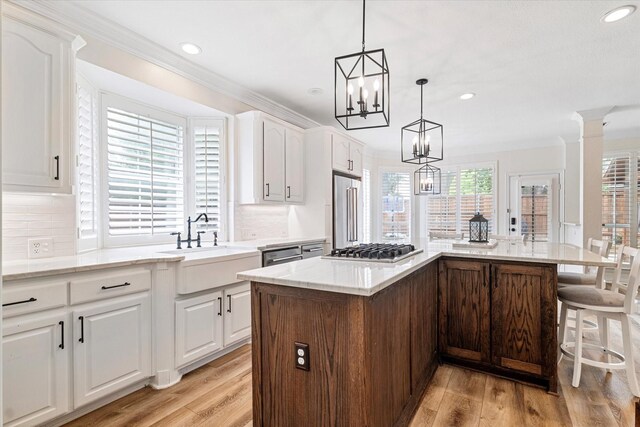 4804 Arbor Glen Dr, Mckinney, TX 75072 - kitchen with appliances with stainless steel finishes, backsplash, recessed lighting, white cabinetry, and light wood-style flooring