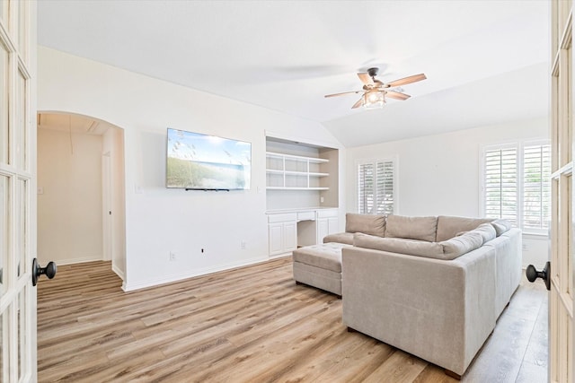 4804 Arbor Glen Dr, Mckinney, TX 75072 - living area featuring ceiling fan, arched walkways, light wood-style floors, built in shelves, and baseboards