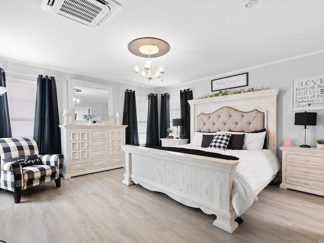 910 N Mill St, Bowie, TX 76230 - bedroom with a chandelier and wood finished floors