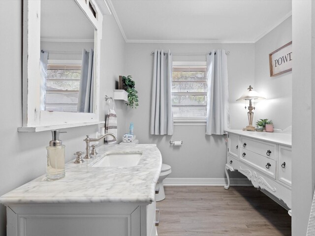 910 N Mill St, Bowie, TX 76230 - bathroom featuring vanity, wood finished floors, healthy amount of natural light, baseboards, and crown molding
