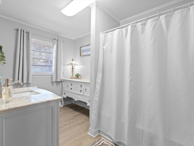 910 N Mill St, Bowie, TX 76230 - bathroom with wood finished floors, vanity, crown molding, and curtained shower