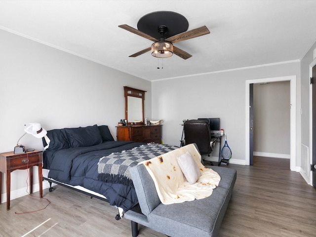 910 N Mill St, Bowie, TX 76230 - bedroom featuring wood finished floors, baseboards, crown molding, ceiling fan, and an office area