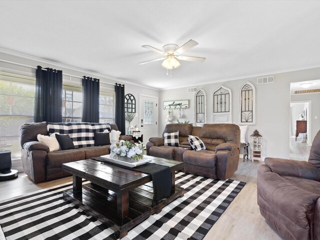 910 N Mill St, Bowie, TX 76230 - living area with a ceiling fan, ornamental molding, and wood finished floors