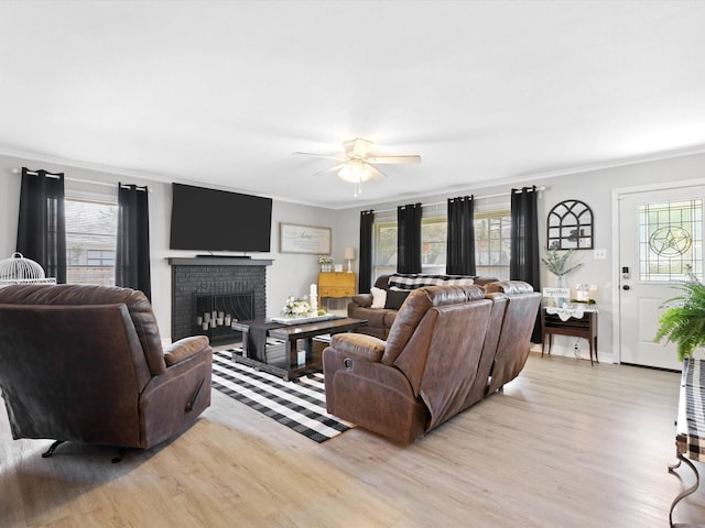 910 N Mill St, Bowie, TX 76230 - living room with light wood-type flooring, crown molding, healthy amount of natural light, and a fireplace