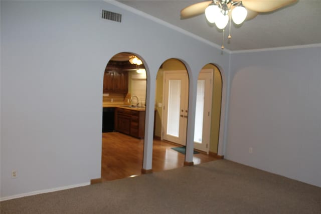 1424 Valley Trl, Mesquite, TX 75149 - spare room with a ceiling fan, light colored carpet, vaulted ceiling, arched walkways, and ornamental molding