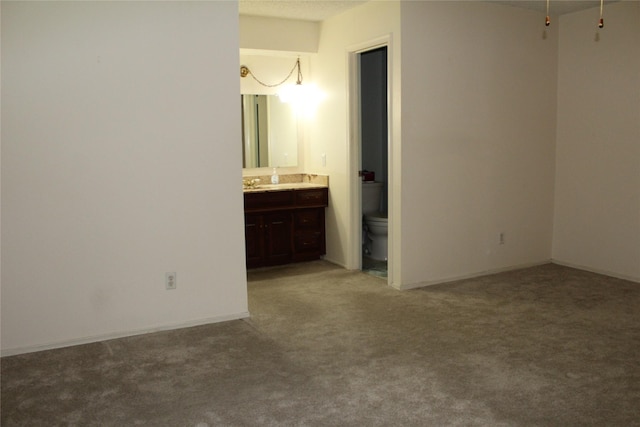1424 Valley Trl, Mesquite, TX 75149 - unfurnished bedroom featuring light colored carpet, ensuite bath, and a sink