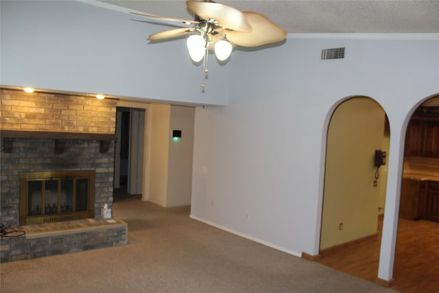 1424 Valley Trl, Mesquite, TX 75149 - unfurnished living room with a ceiling fan, carpet, a fireplace, crown molding, and a towering ceiling