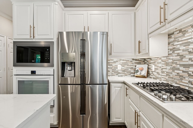 726 Nettleton Dr, Southlake, TX 76092 - kitchen featuring stainless steel appliances, white cabinets, tasteful backsplash, crown molding, and light stone counters