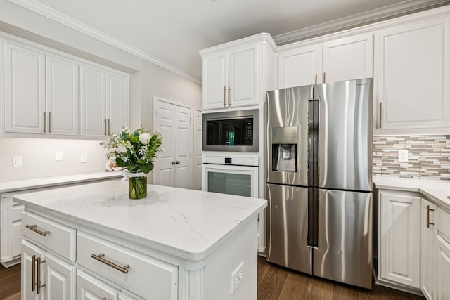726 Nettleton Dr, Southlake, TX 76092 - kitchen with stainless steel appliances, white cabinets, crown molding, dark wood-type flooring, and decorative backsplash