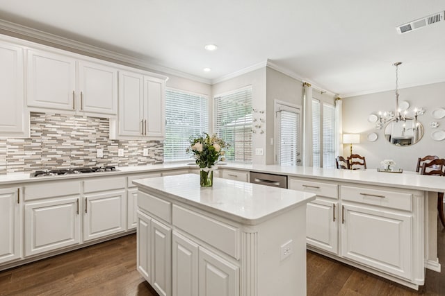 726 Nettleton Dr, Southlake, TX 76092 - kitchen with a center island, crown molding, white gas cooktop, a chandelier, and dark wood-style flooring