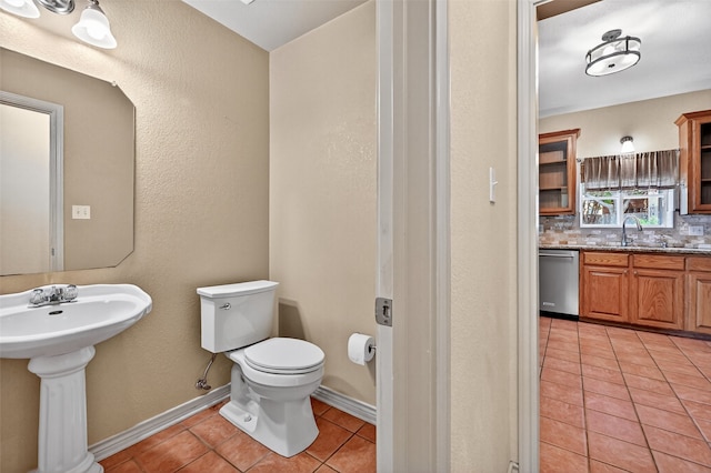 2004 Monte Cristo Dr, Sherman, TX 75092 - bathroom featuring tile patterned flooring, backsplash, and a textured wall
