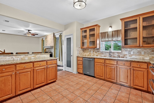 2004 Monte Cristo Dr, Sherman, TX 75092 - kitchen with stainless steel dishwasher, decorative backsplash, a ceiling fan, and brown cabinets