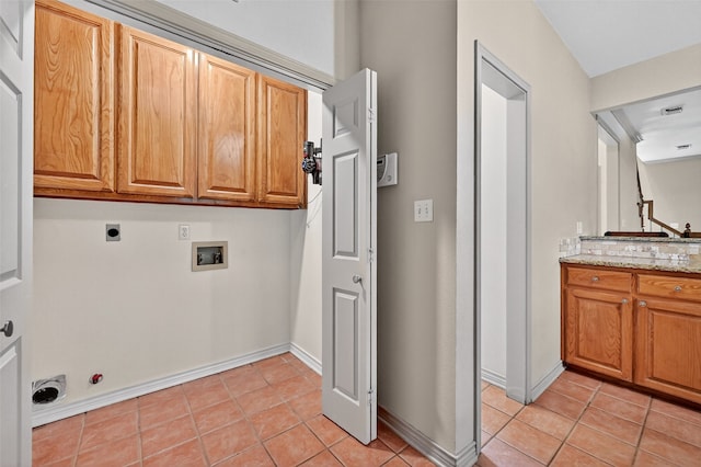 2004 Monte Cristo Dr, Sherman, TX 75092 - laundry area featuring washer hookup, cabinet space, electric dryer hookup, light tile patterned flooring, and hookup for a gas dryer