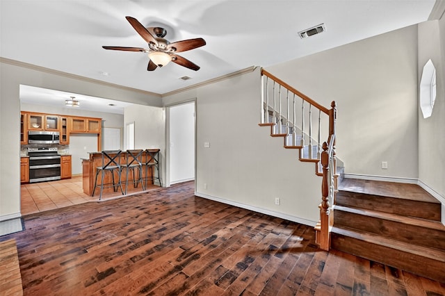 2004 Monte Cristo Dr, Sherman, TX 75092 - living room with ceiling fan, wood finished floors, stairs, and crown molding
