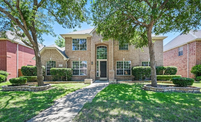 14877 Snowshill Dr, Frisco, TX 75035 - traditional-style house with brick siding and a front lawn