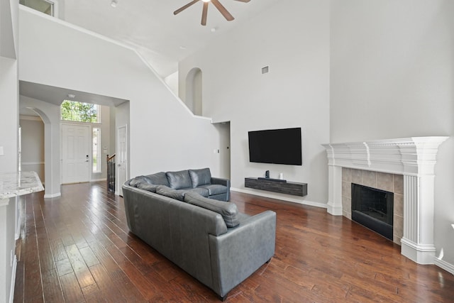 14877 Snowshill Dr, Frisco, TX 75035 - living area featuring ceiling fan, dark wood-style floors, high vaulted ceiling, baseboards, and arched walkways