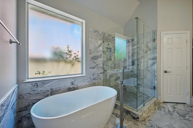 14877 Snowshill Dr, Frisco, TX 75035 - bathroom featuring marble tiled floors, a marble finish shower, tile walls, and a soaking tub