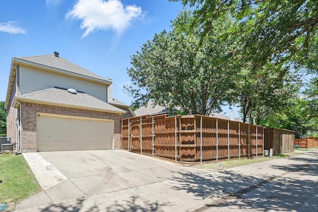 14877 Snowshill Dr, Frisco, TX 75035 - view of front of property featuring brick siding, concrete driveway, roof with shingles, and cooling unit