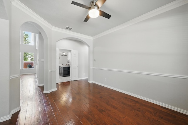 14877 Snowshill Dr, Frisco, TX 75035 - empty room featuring arched walkways, ceiling fan, dark wood-style flooring, baseboards, and ornamental molding