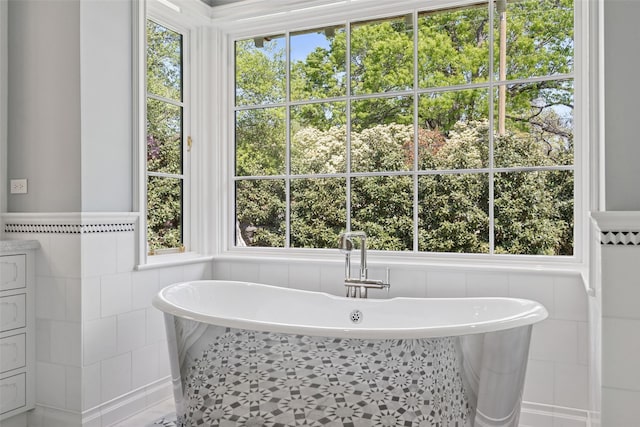 4400 Belfort Pl, Highland Park, TX 75205 - bathroom with tile walls, a freestanding bath, and plenty of natural light