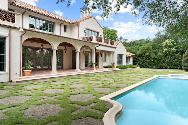 4400 Belfort Pl, Highland Park, TX 75205 - back of house with stucco siding, a tile roof, an outdoor pool, and french doors