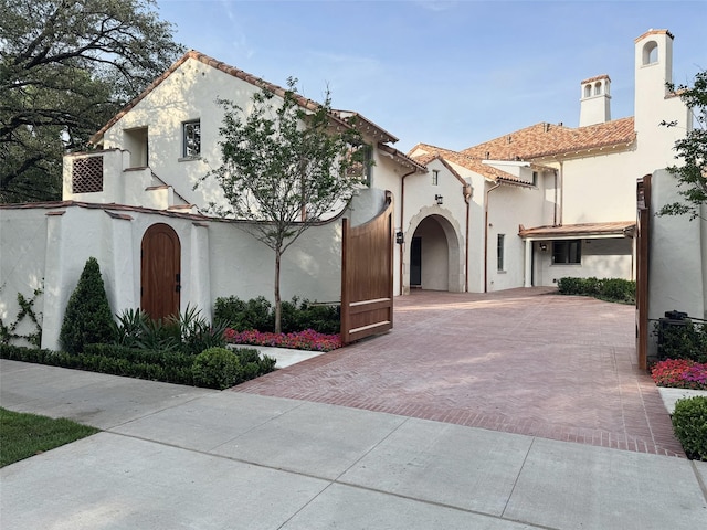 4400 Belfort Pl, Highland Park, TX 75205 - mediterranean / spanish home featuring stucco siding, a chimney, and a tile roof