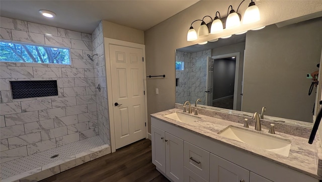 147 Carolynn Rd, Mabank, TX 75156 - full bathroom featuring double vanity, wood finished floors, and tiled shower