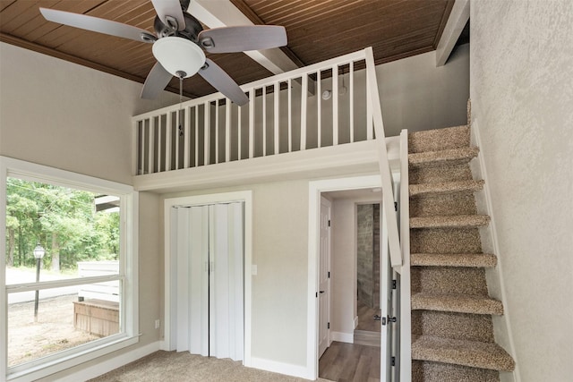 147 Carolynn Rd, Mabank, TX 75156 - staircase with a towering ceiling, a ceiling fan, wooden ceiling, baseboards, and carpet flooring