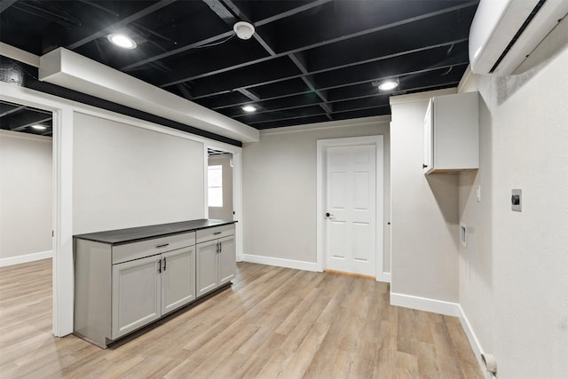 147 Carolynn Rd, Mabank, TX 75156 - basement featuring a wall mounted AC, baseboards, and light wood-type flooring