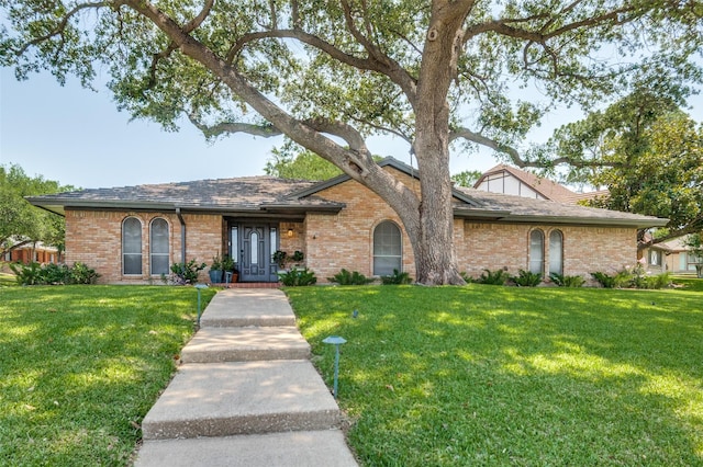 1905 Red Cypress Ct, Arlington, TX 76012 - view of front facade with brick siding and a front lawn
