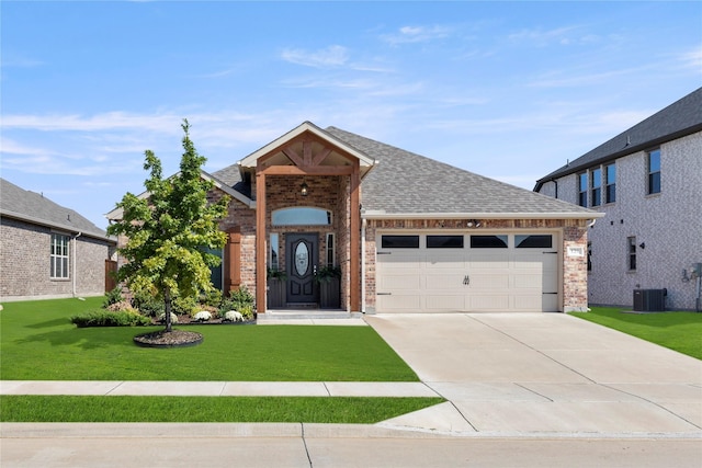 129 Braves Way, Lavon, TX 75166 - view of front facade with brick siding, a garage, concrete driveway, roof with shingles, and a front lawn