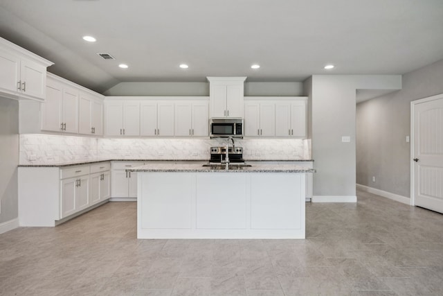 129 Braves Way, Lavon, TX 75166 - kitchen with appliances with stainless steel finishes, backsplash, light stone counters, white cabinets, and recessed lighting