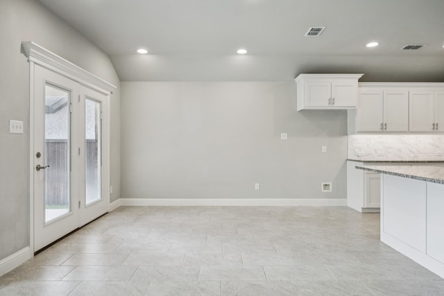 129 Braves Way, Lavon, TX 75166 - kitchen featuring white cabinets, light stone countertops, recessed lighting, tasteful backsplash, and baseboards