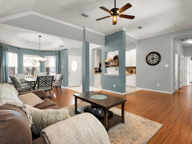 3401 Muleshoe Ln, Fort Worth, TX 76179 - living area featuring a chandelier, ceiling fan, light wood-type flooring, baseboards, and crown molding