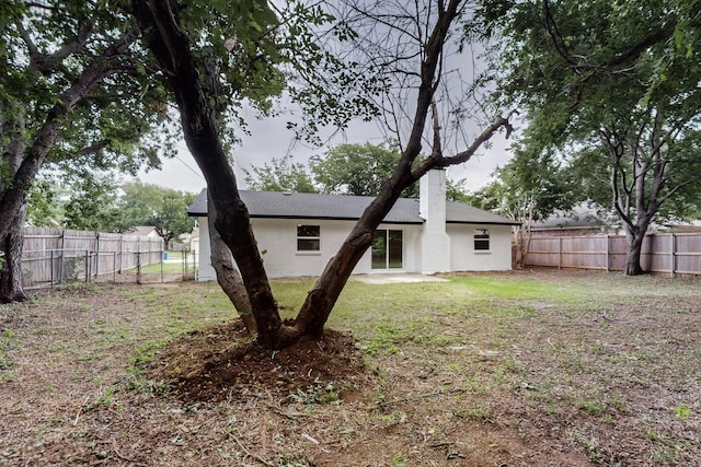 6821 Mickey Dr, Watauga, TX 76148 - rear view of property featuring a chimney and stucco siding