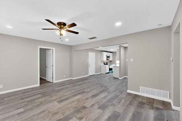 6821 Mickey Dr, Watauga, TX 76148 - unfurnished living room featuring ceiling fan, wood finished floors, baseboards, and recessed lighting