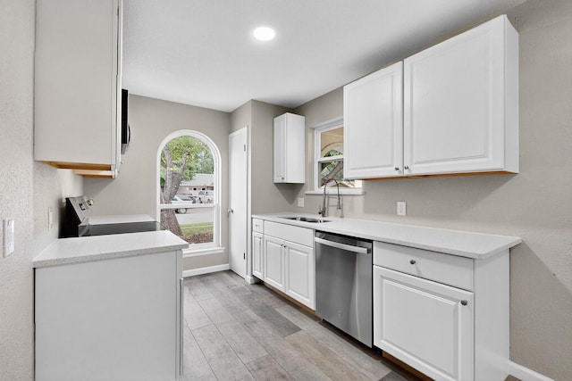 6821 Mickey Dr, Watauga, TX 76148 - kitchen featuring stainless steel appliances, white cabinetry, light wood-style floors, a sink, and recessed lighting