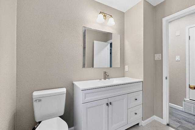 6821 Mickey Dr, Watauga, TX 76148 - bathroom featuring vanity, toilet, and baseboards