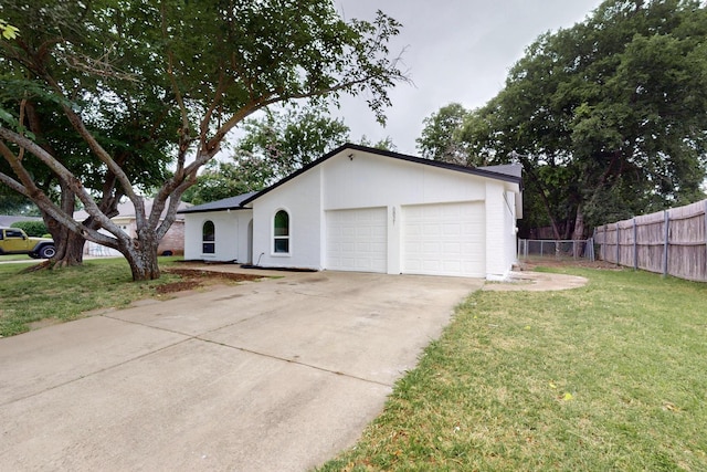 6821 Mickey Dr, Watauga, TX 76148 - view of front of property featuring a garage, concrete driveway, and stucco siding