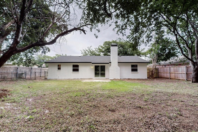 6821 Mickey Dr, Watauga, TX 76148 - back of property with a chimney and stucco siding