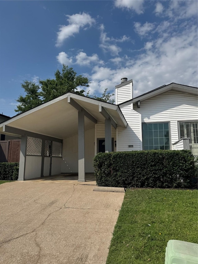 4831 Spindrift, Garland, TX 75043 - view of front of house with a front lawn, a chimney, an attached carport, and concrete driveway