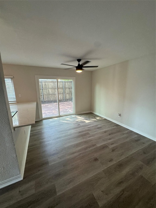 4831 Spindrift, Garland, TX 75043 - empty room featuring ceiling fan, dark wood-type flooring, and baseboards